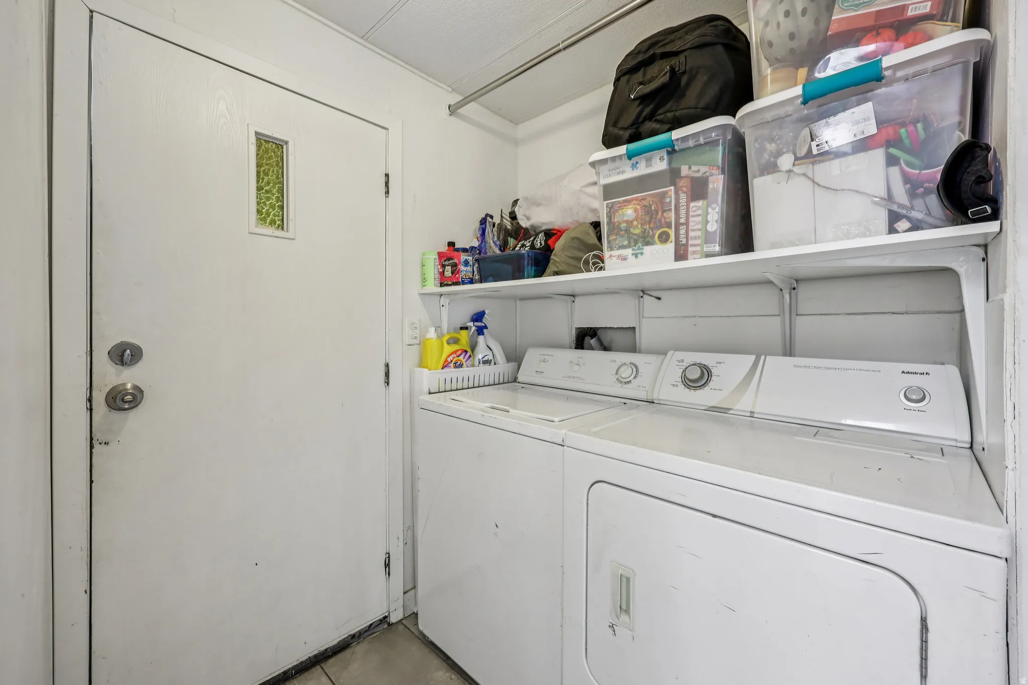 Laundry area with washer and clothes dryer and concrete floors