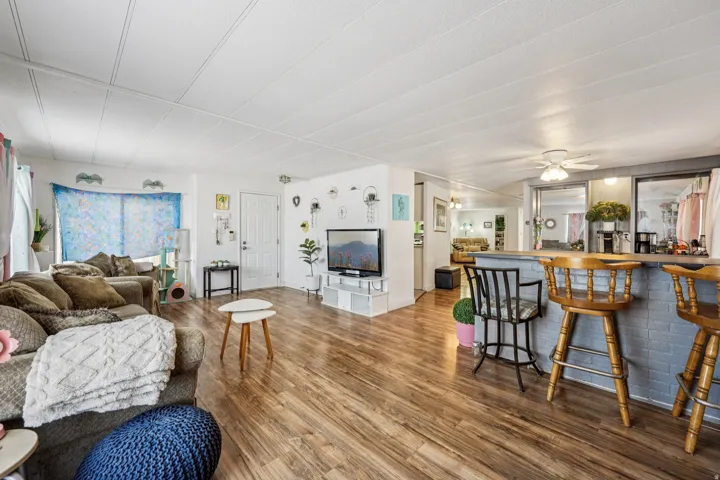 Living room featuring wood finished floors and a ceiling fan