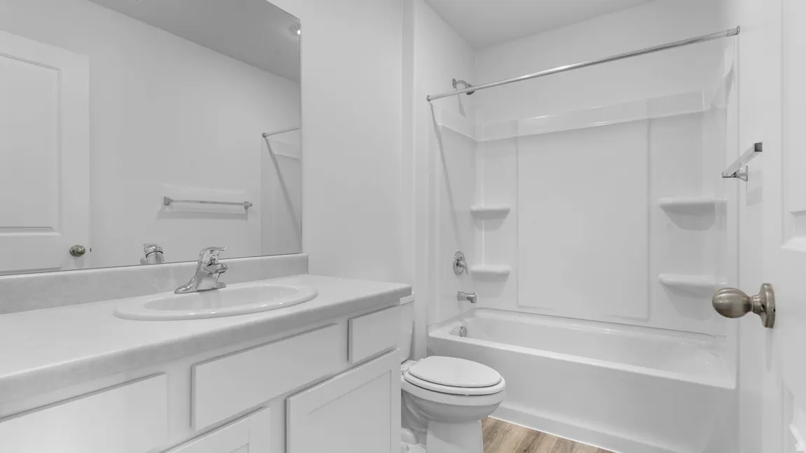 Full bath with vanity, light wood-type flooring, and bathing tub / shower combination