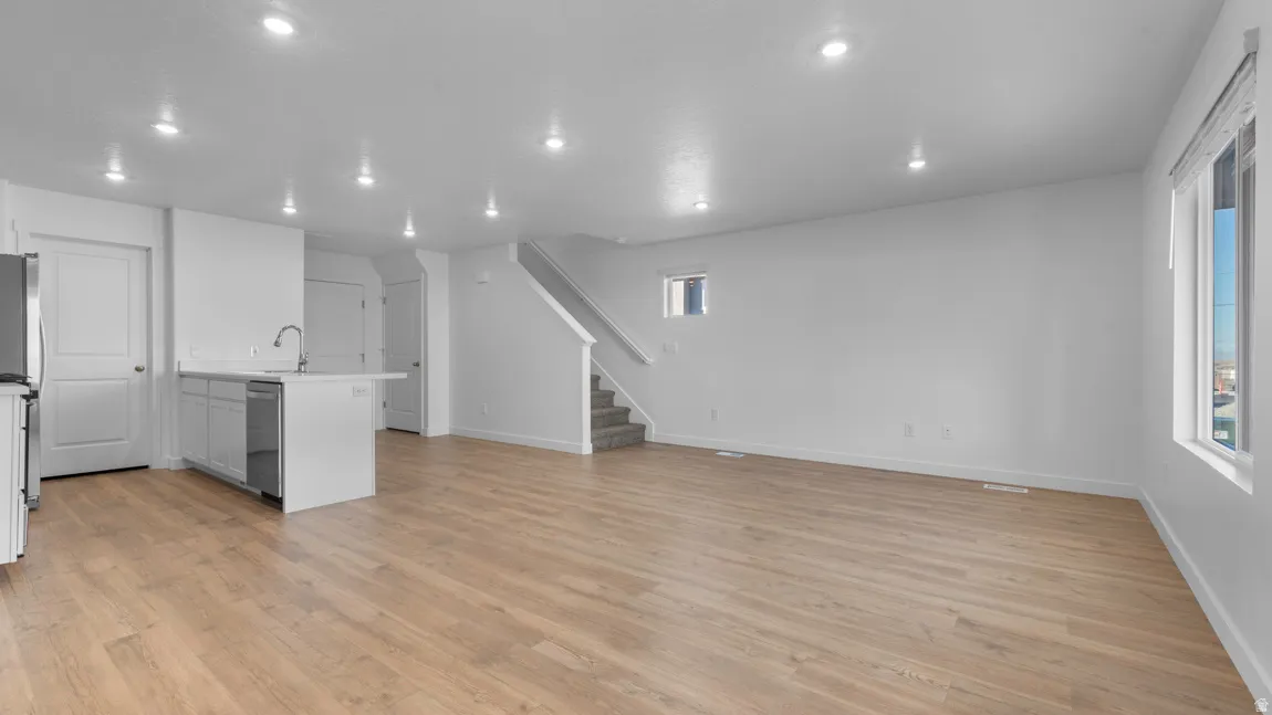 Unfurnished living room featuring light wood-type flooring and recessed lighting