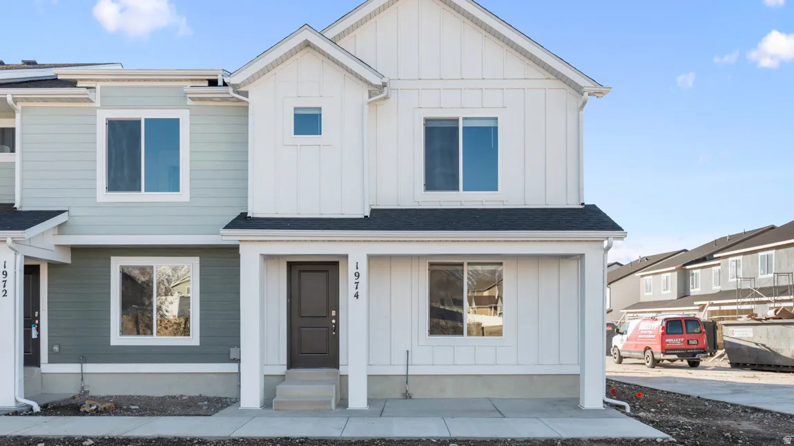 Modern inspired farmhouse featuring board and batten siding, roof with shingles, and a residential view