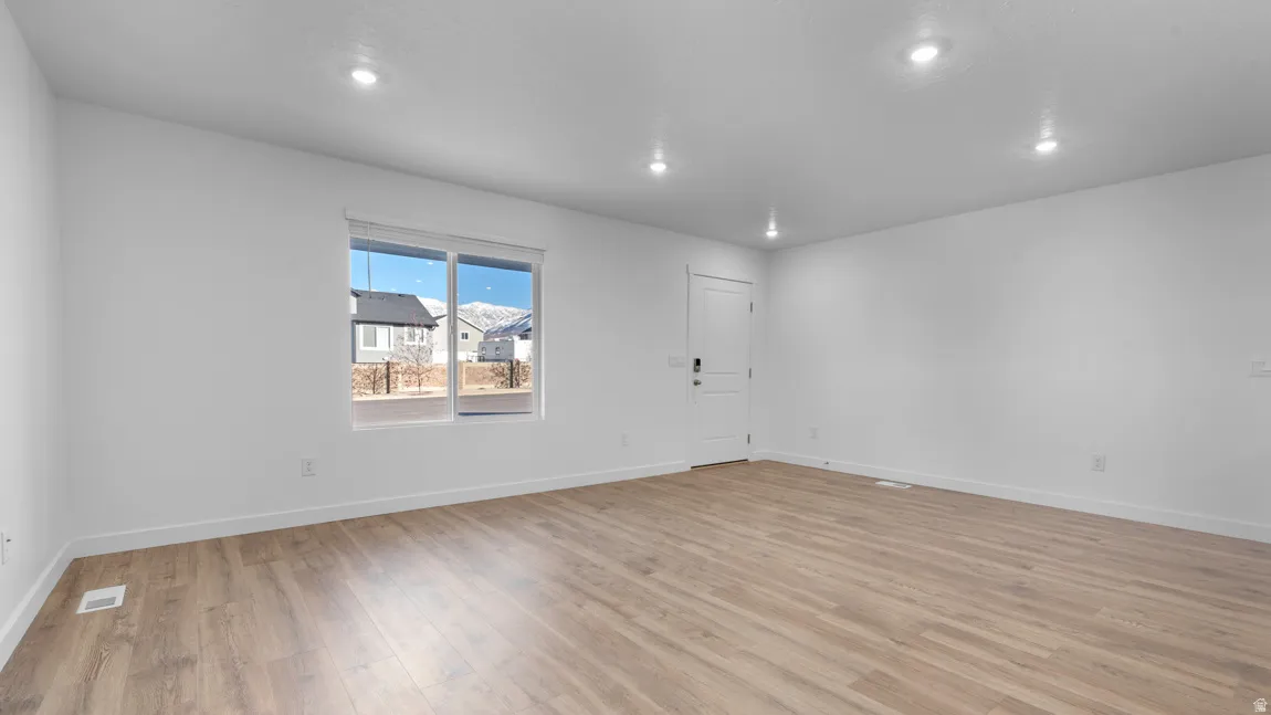 Spare room with light wood-style flooring and recessed lighting