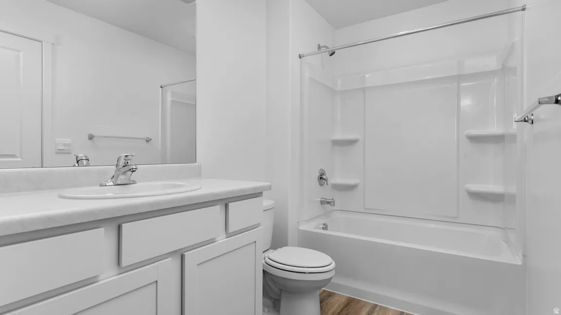 Full bathroom with vanity, bathtub / shower combination, and light wood-style floors