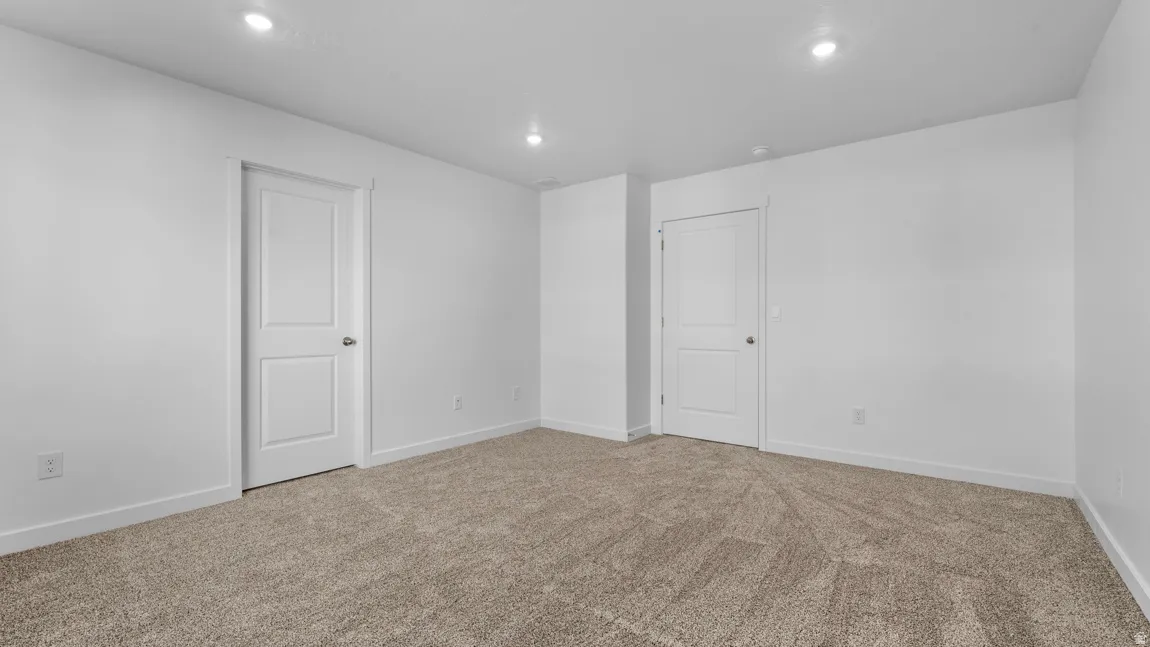 Unfurnished room featuring light colored carpet and recessed lighting