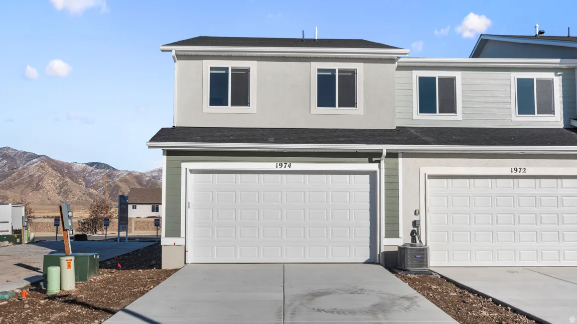 Garage with driveway and a mountain view