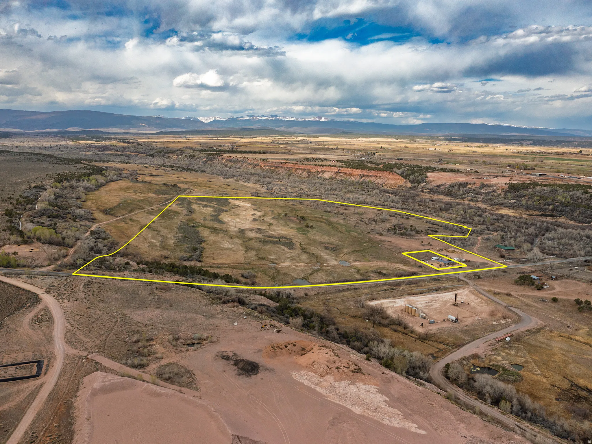 Aerial view of sparsely populated area featuring mountains and property boundaries highlighted