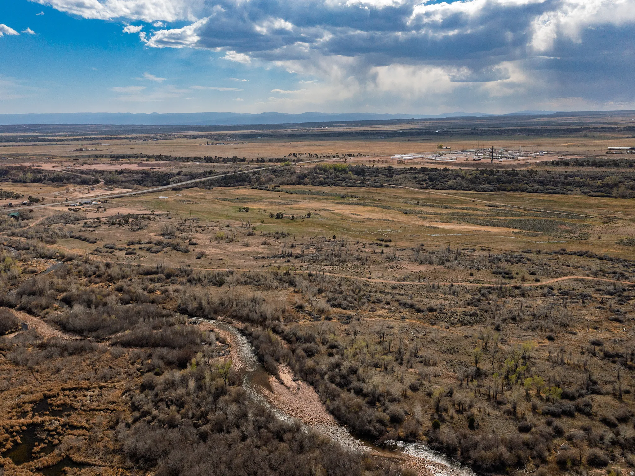 Aerial view of sparsely populated area featuring a mountain backdrop and a desert landscape