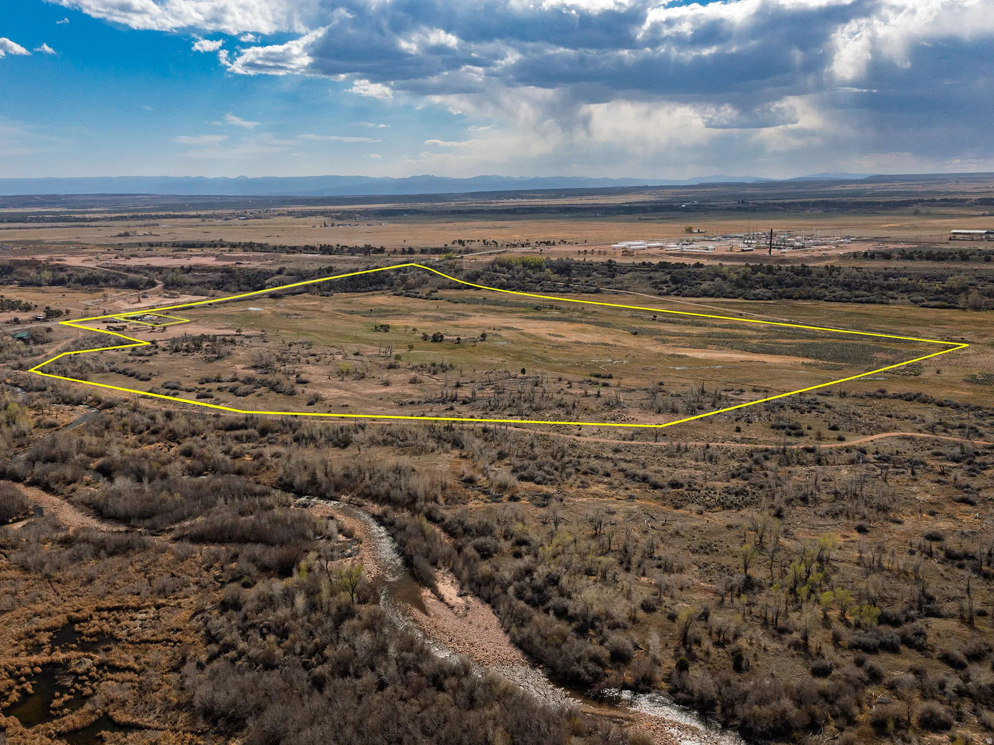 Aerial view of sparsely populated area with mountains and a desert landscape