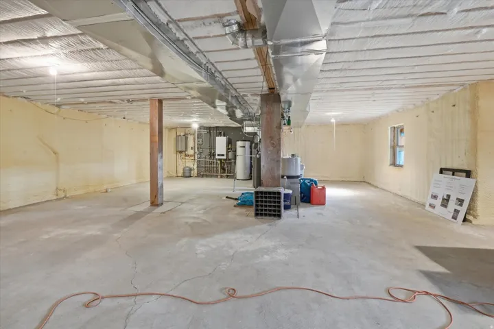 Basement featuring tankless water heater