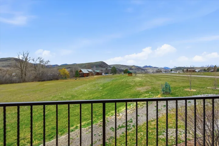 View of grassy yard featuring a mountain view and a rural view