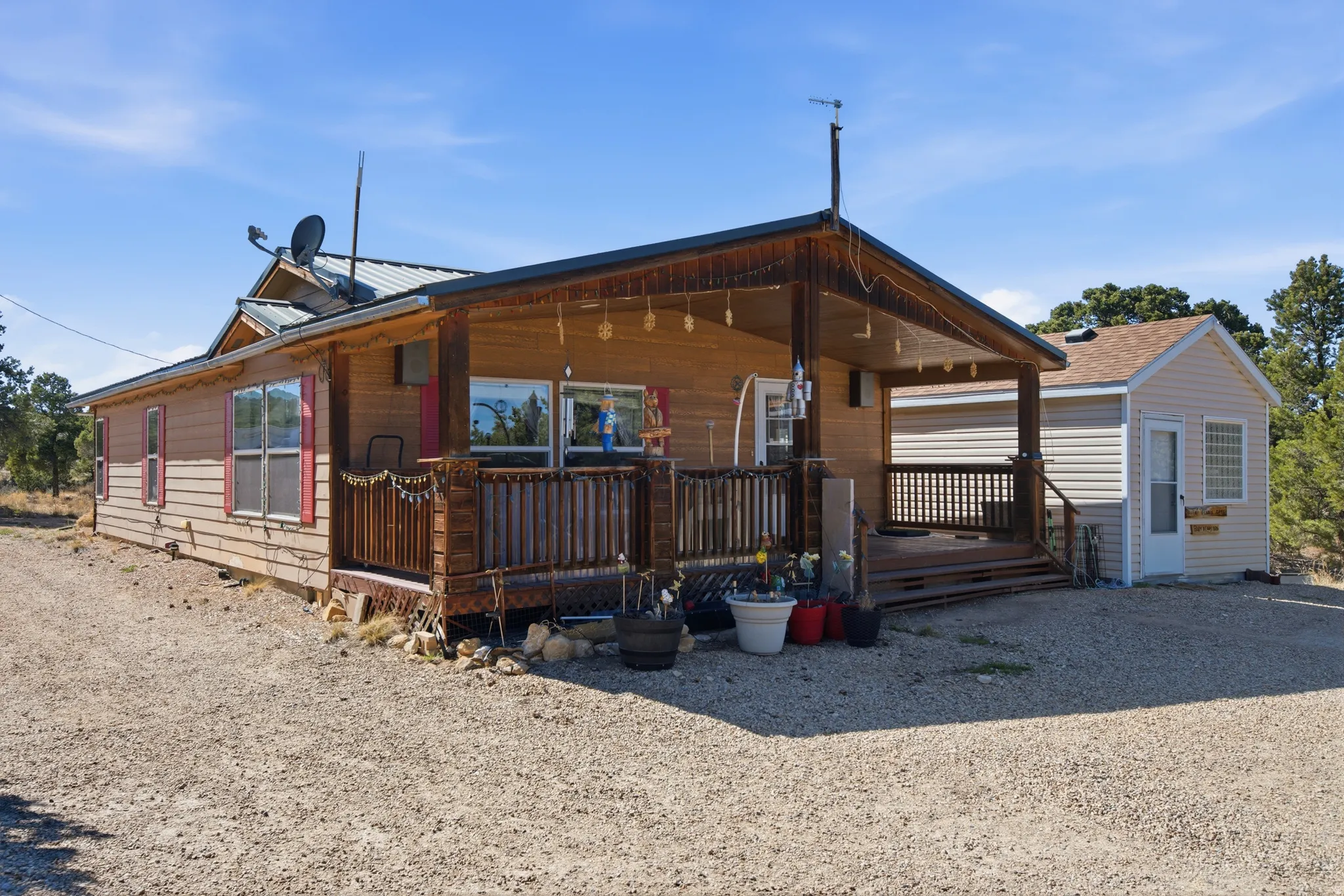 View of front facade featuring covered porch and a metal roof