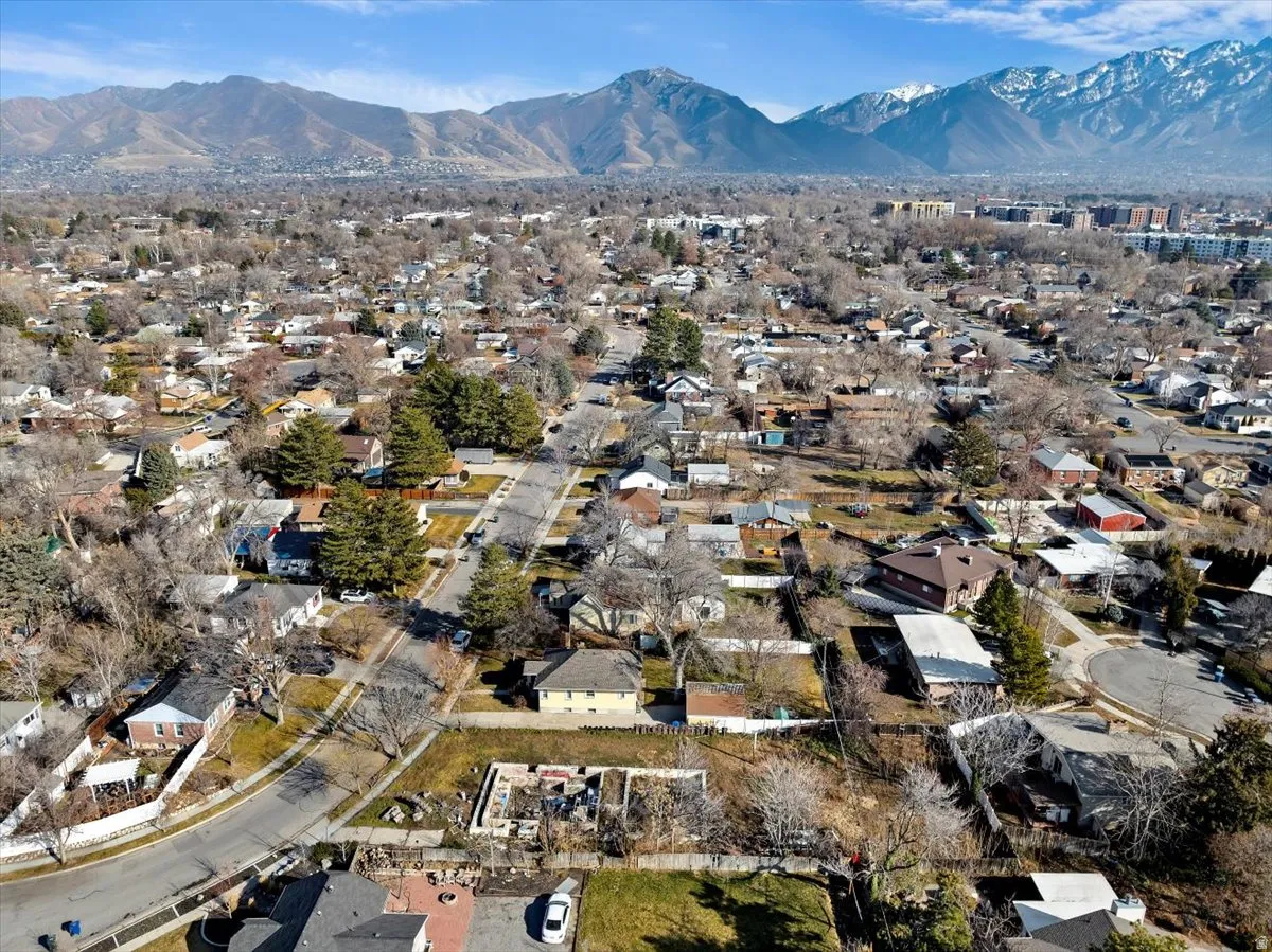 Aerial overview of property's location featuring a mountainous background and nearby suburban area