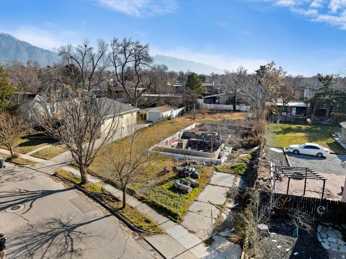 Aerial view of residential area featuring a mountainous background