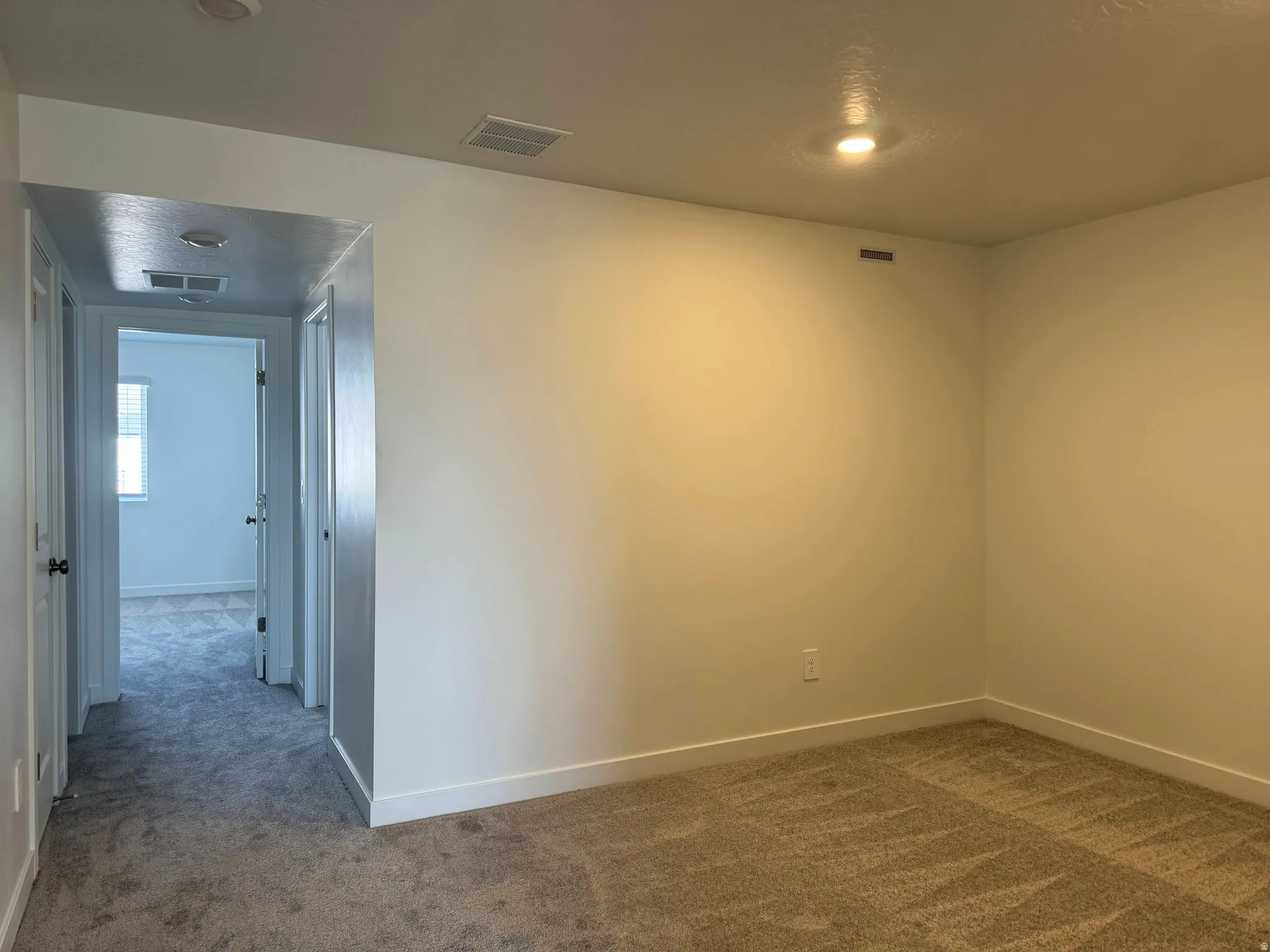 Carpeted empty room featuring baseboards