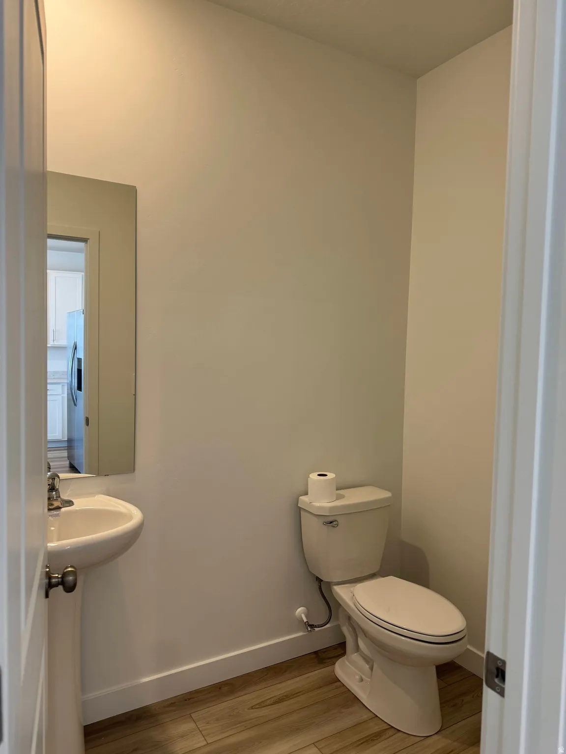 Bathroom featuring toilet and light wood-type flooring