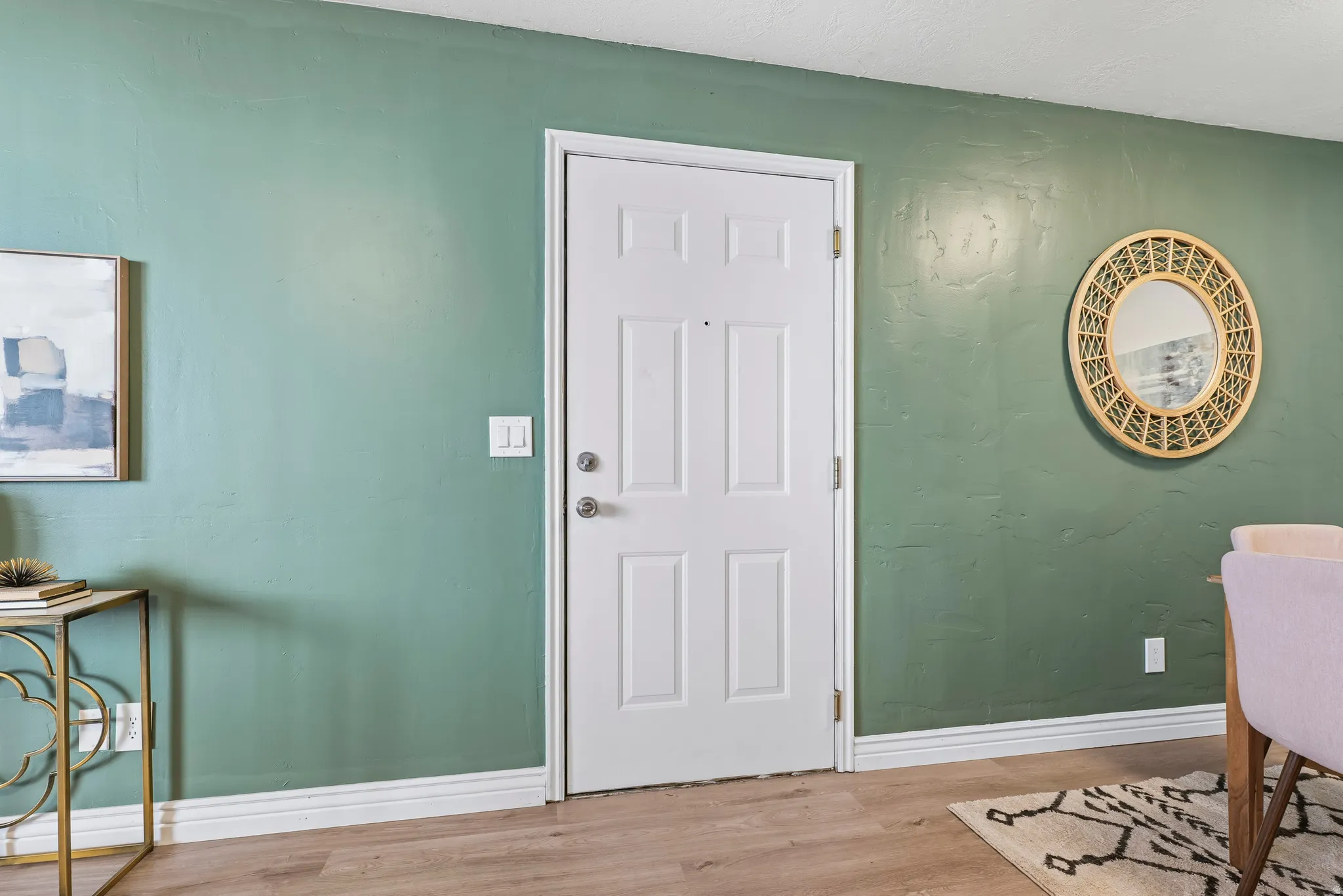 Entryway with light wood-type flooring and baseboards