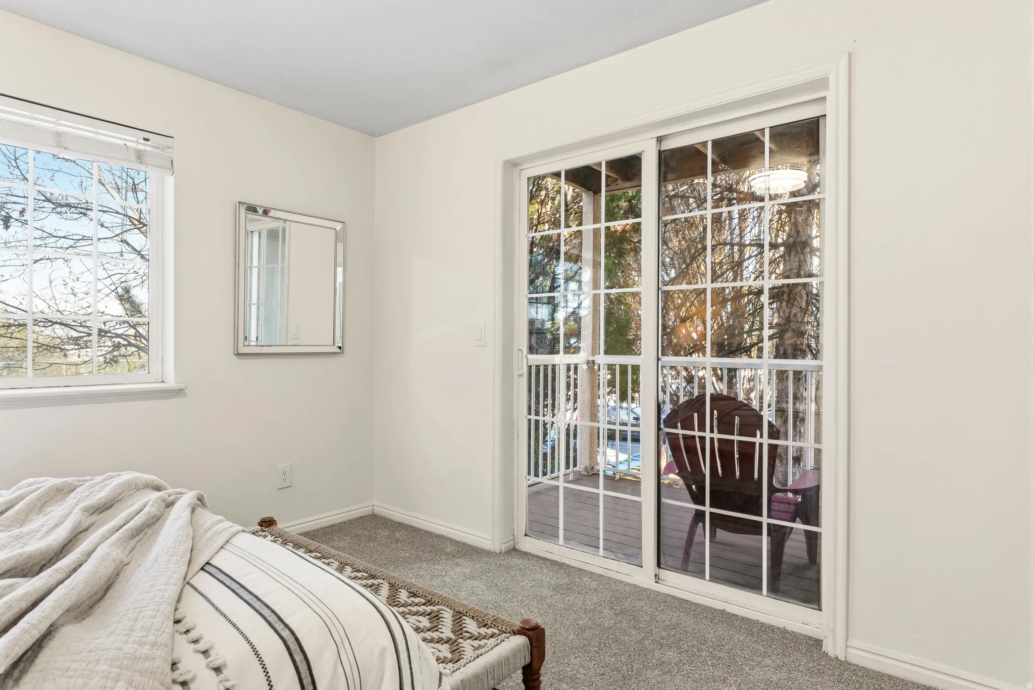 Bedroom with carpet and access to exterior
