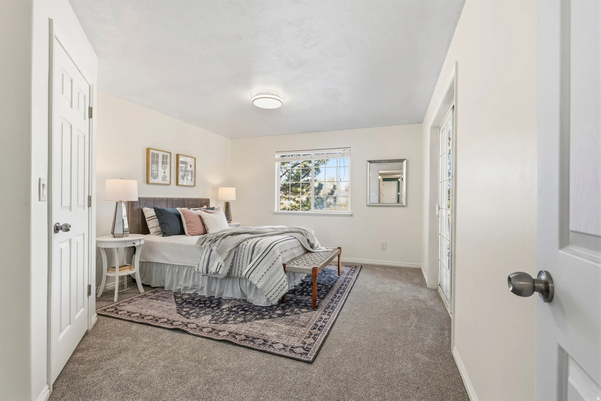 Bedroom featuring baseboards and light carpet