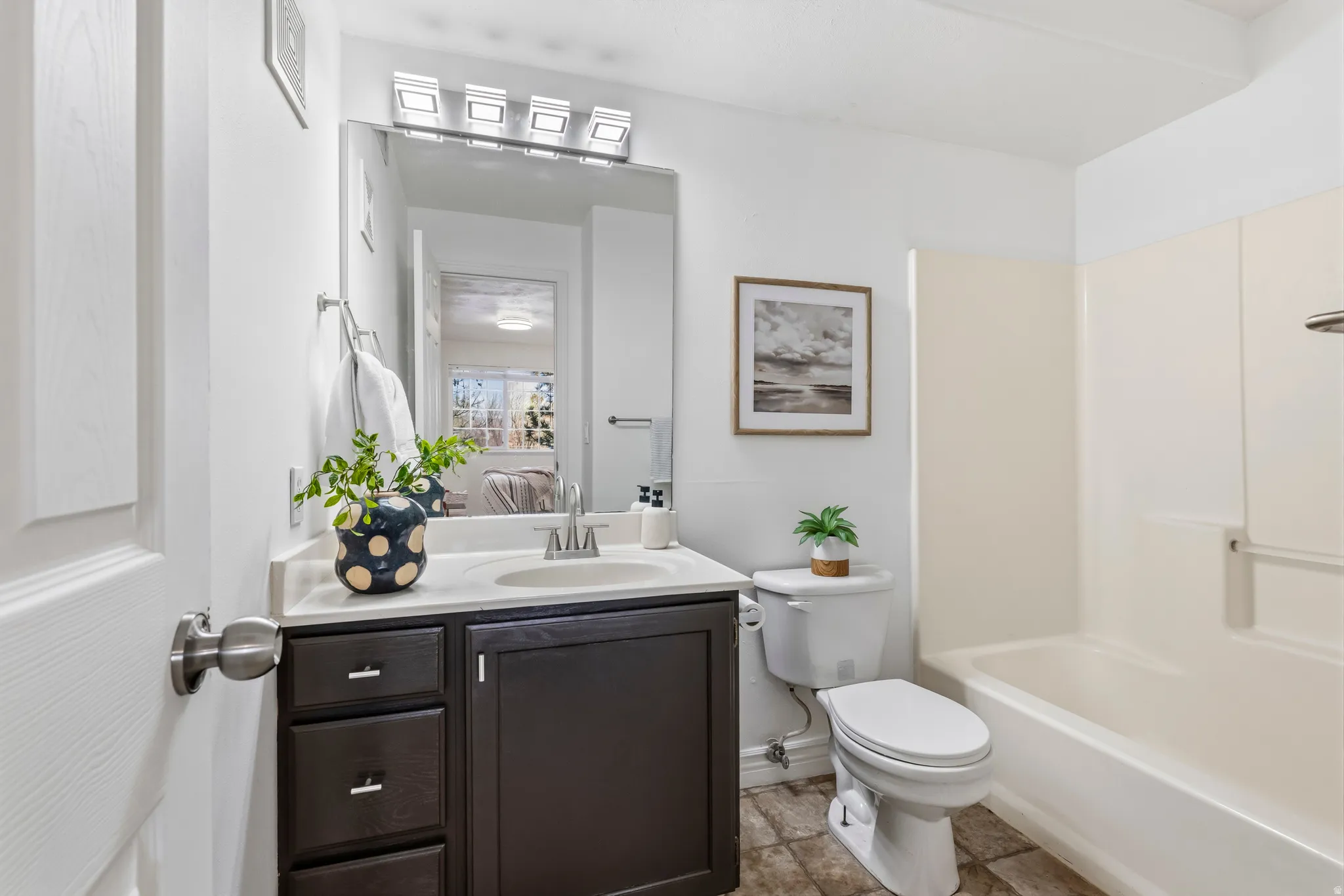 Ensuite bathroom featuring vanity and  shower combination