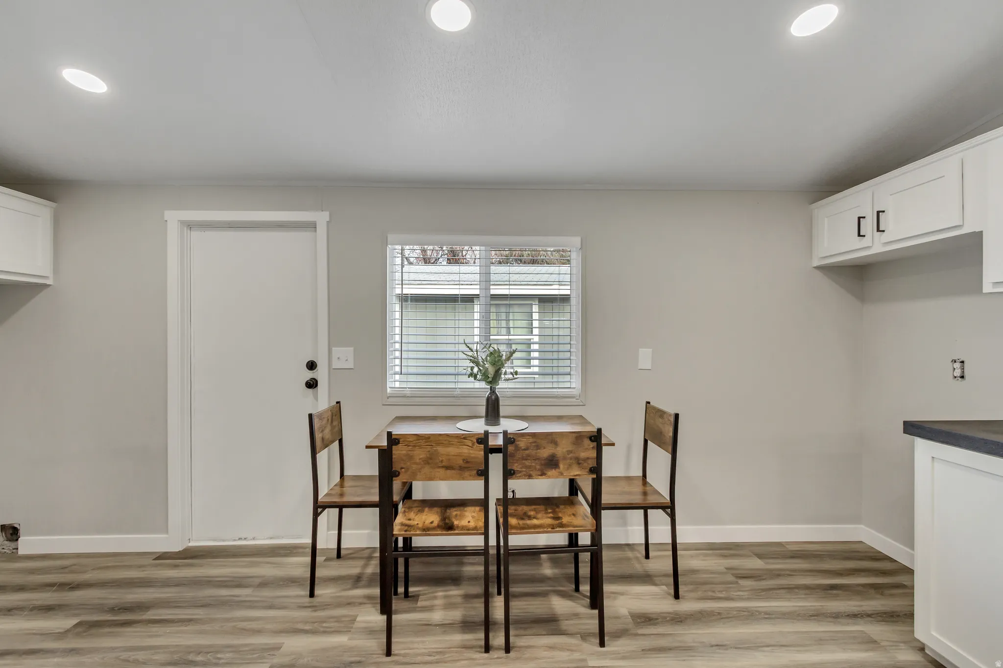 Dining area featuring light wood-style flooring and recessed lighting