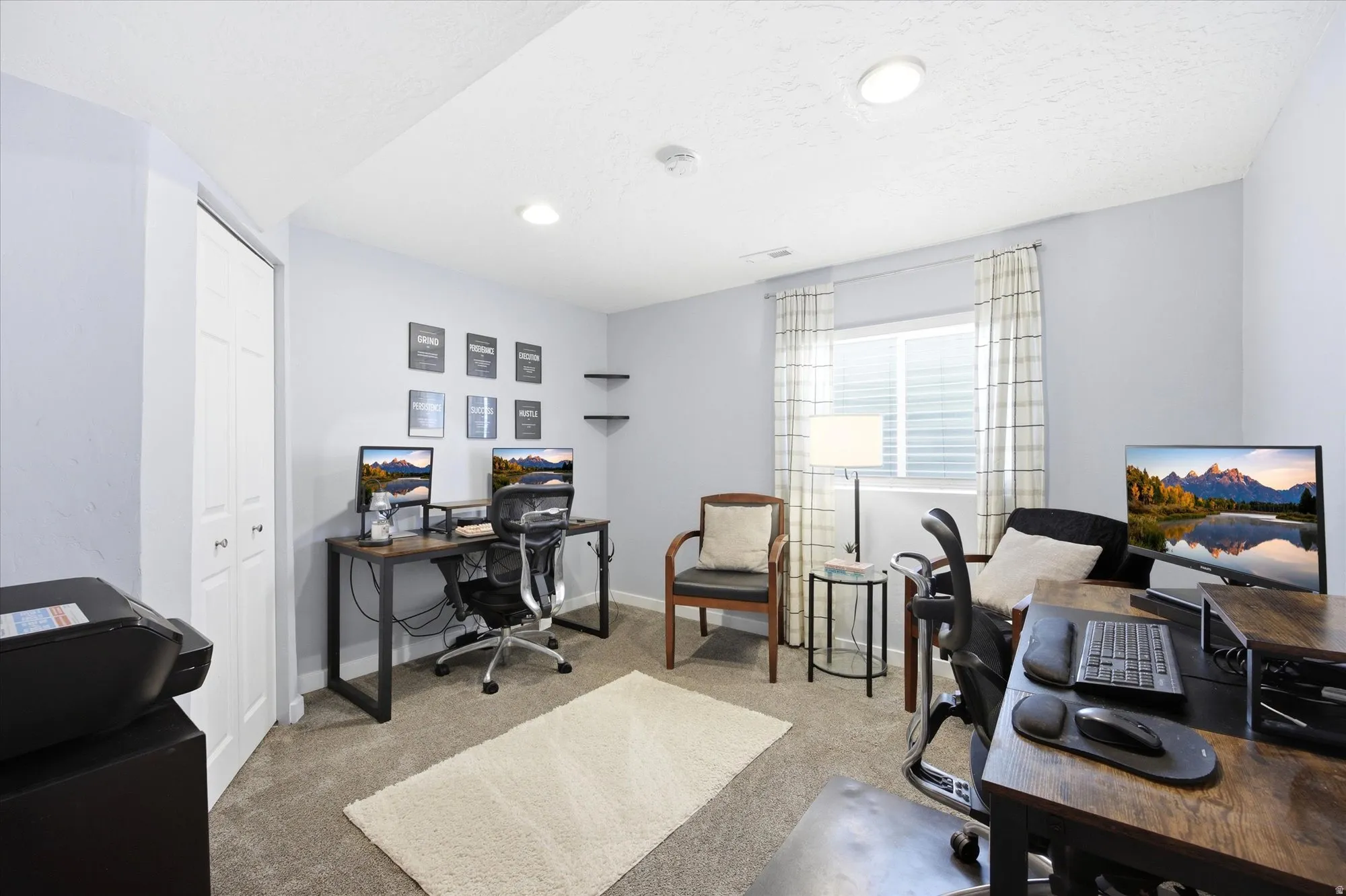 Office space featuring light colored carpet and recessed lighting