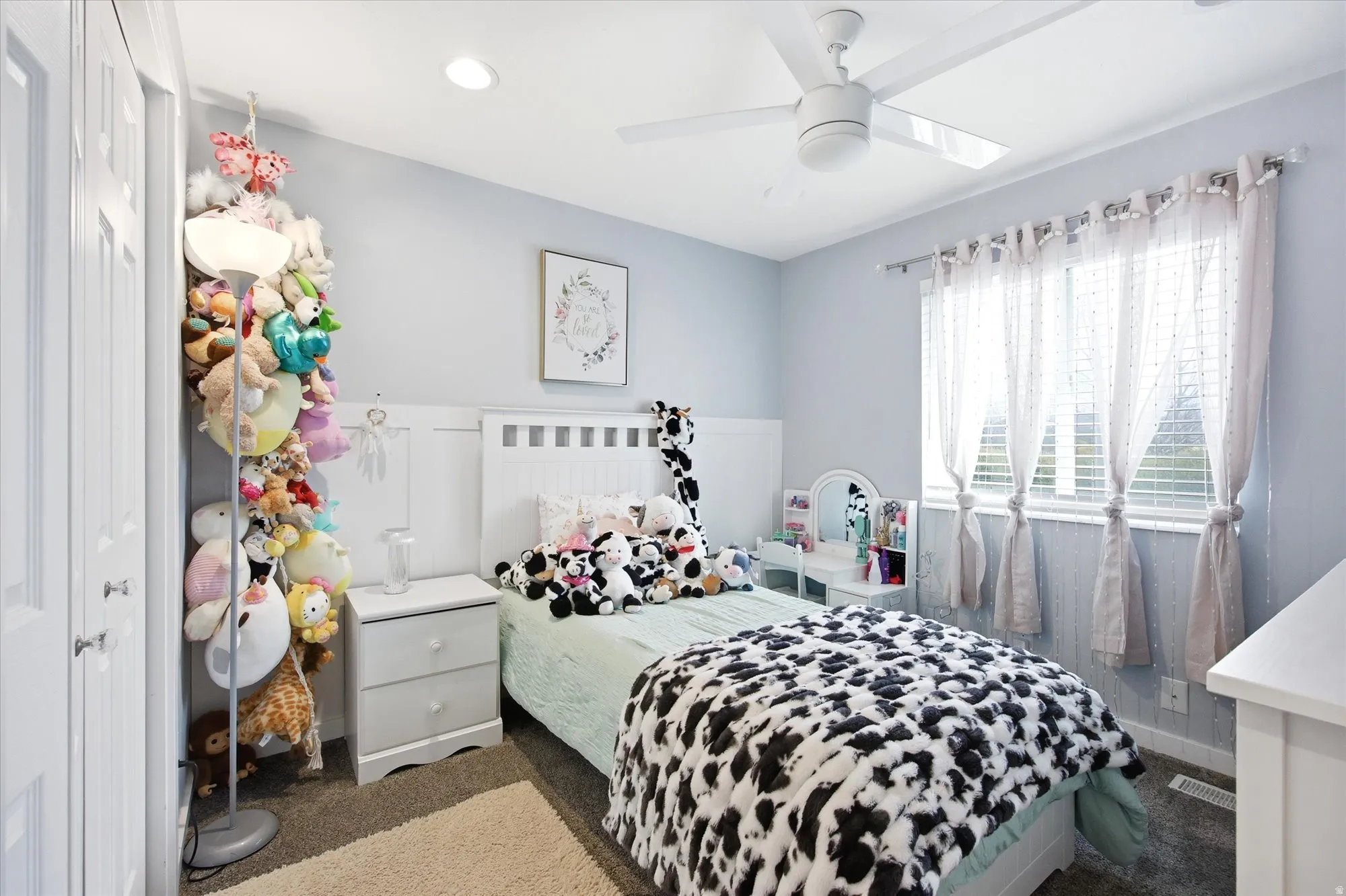 Carpeted bedroom featuring ceiling fan and recessed lighting