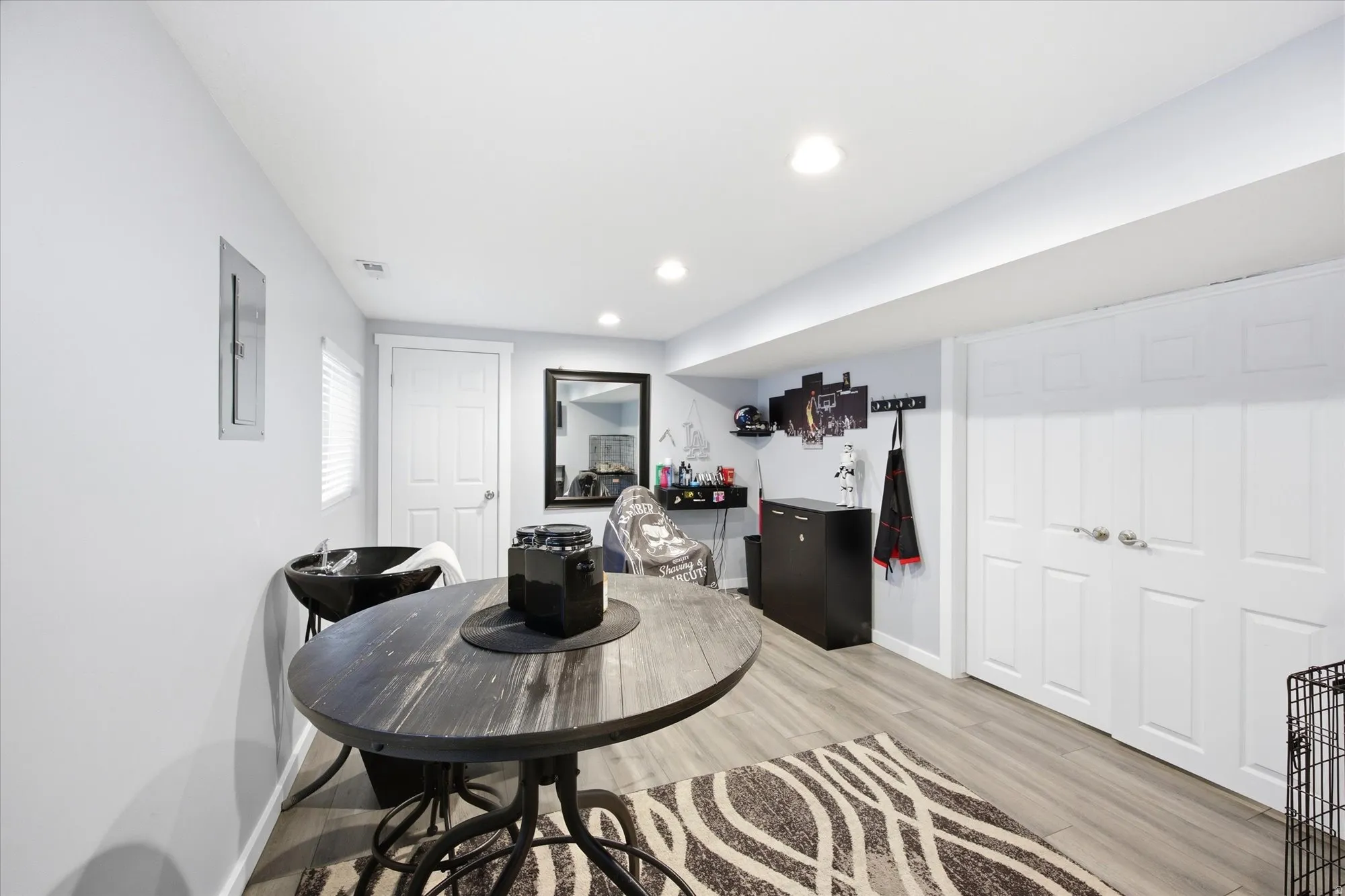 Dining area with light wood-type flooring, recessed lighting, and electric panel