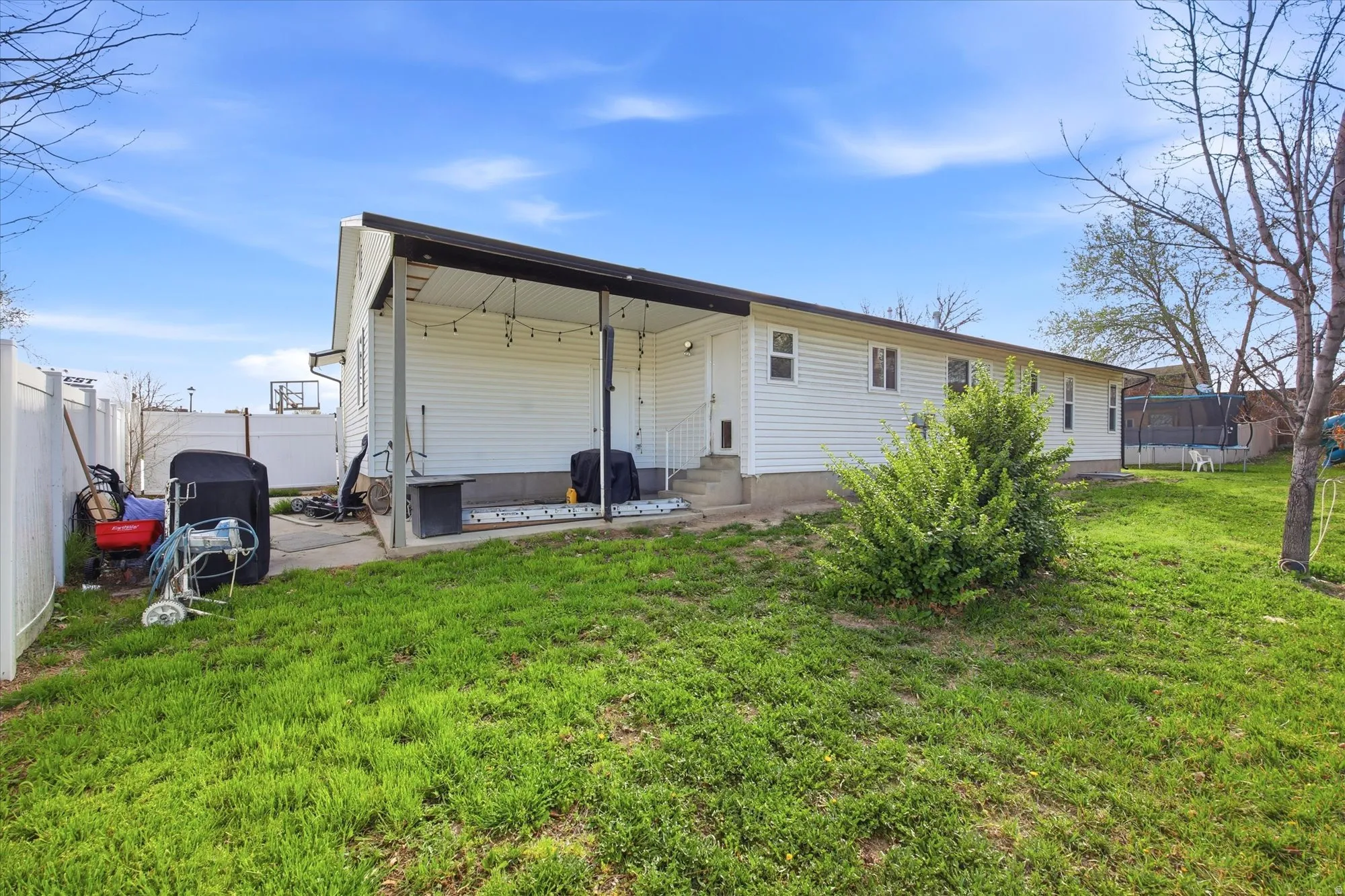 Back of house featuring a patio area, a fenced backyard, and entry steps