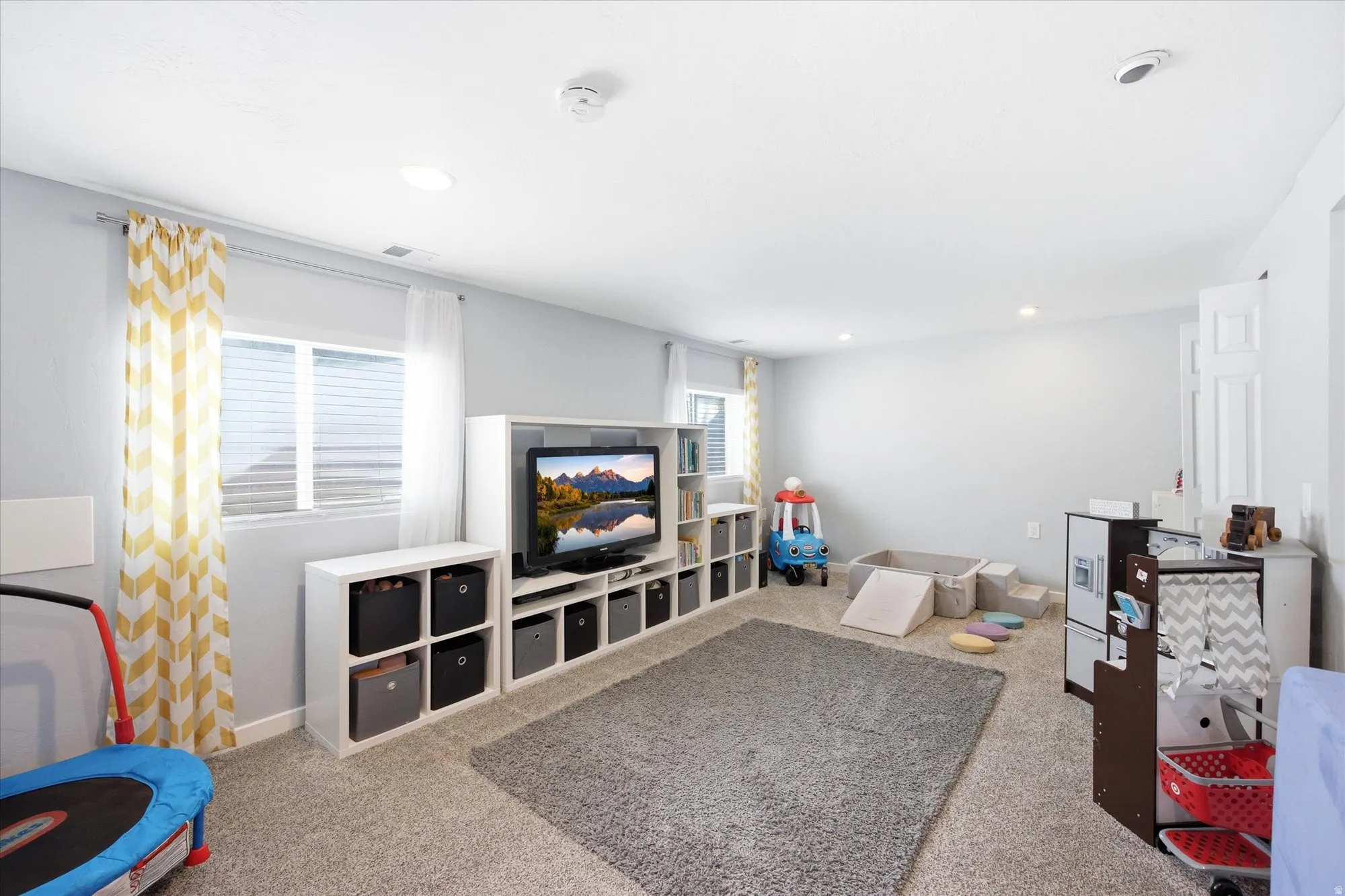Game room with light carpet and recessed lighting