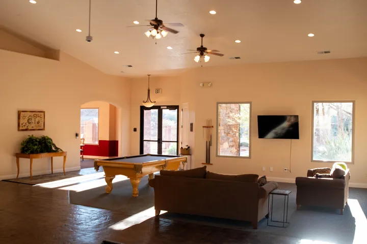 Recreation room featuring recessed lighting, billiards table, a ceiling fan, arched walkways, and a high ceiling