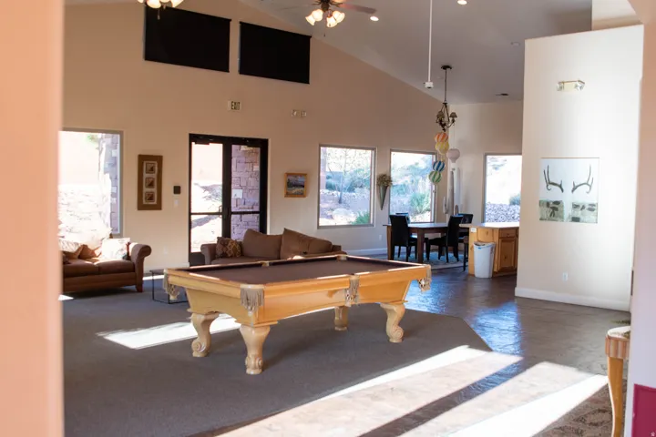 Rec room with vaulted ceiling, pool table, and a ceiling fan