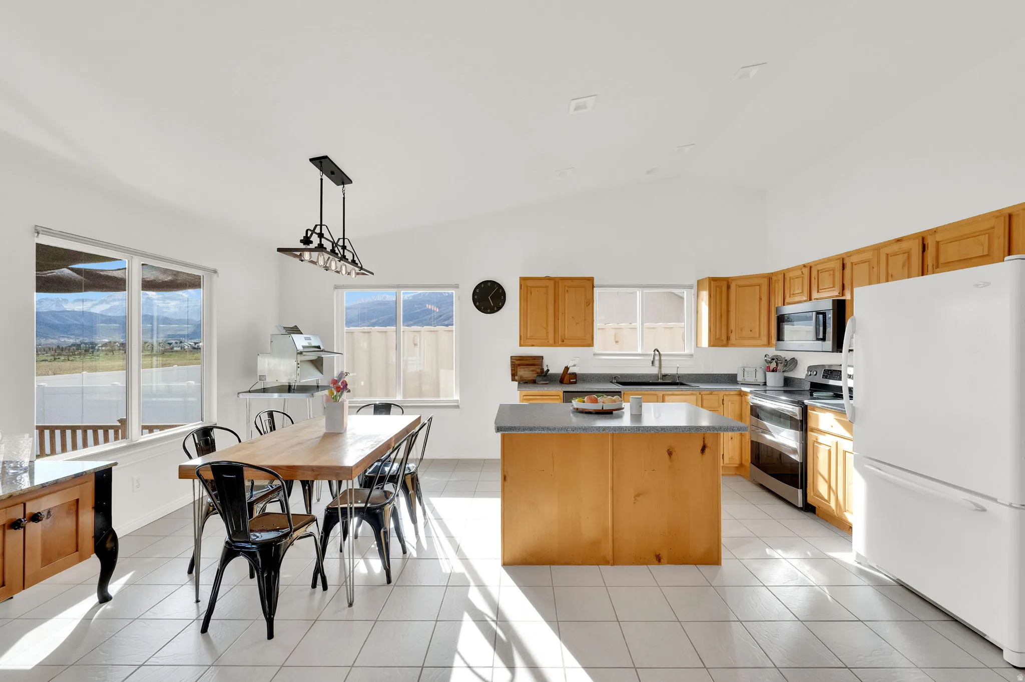 Kitchen featuring vaulted ceiling, a kitchen island, and decorative light fixtures
