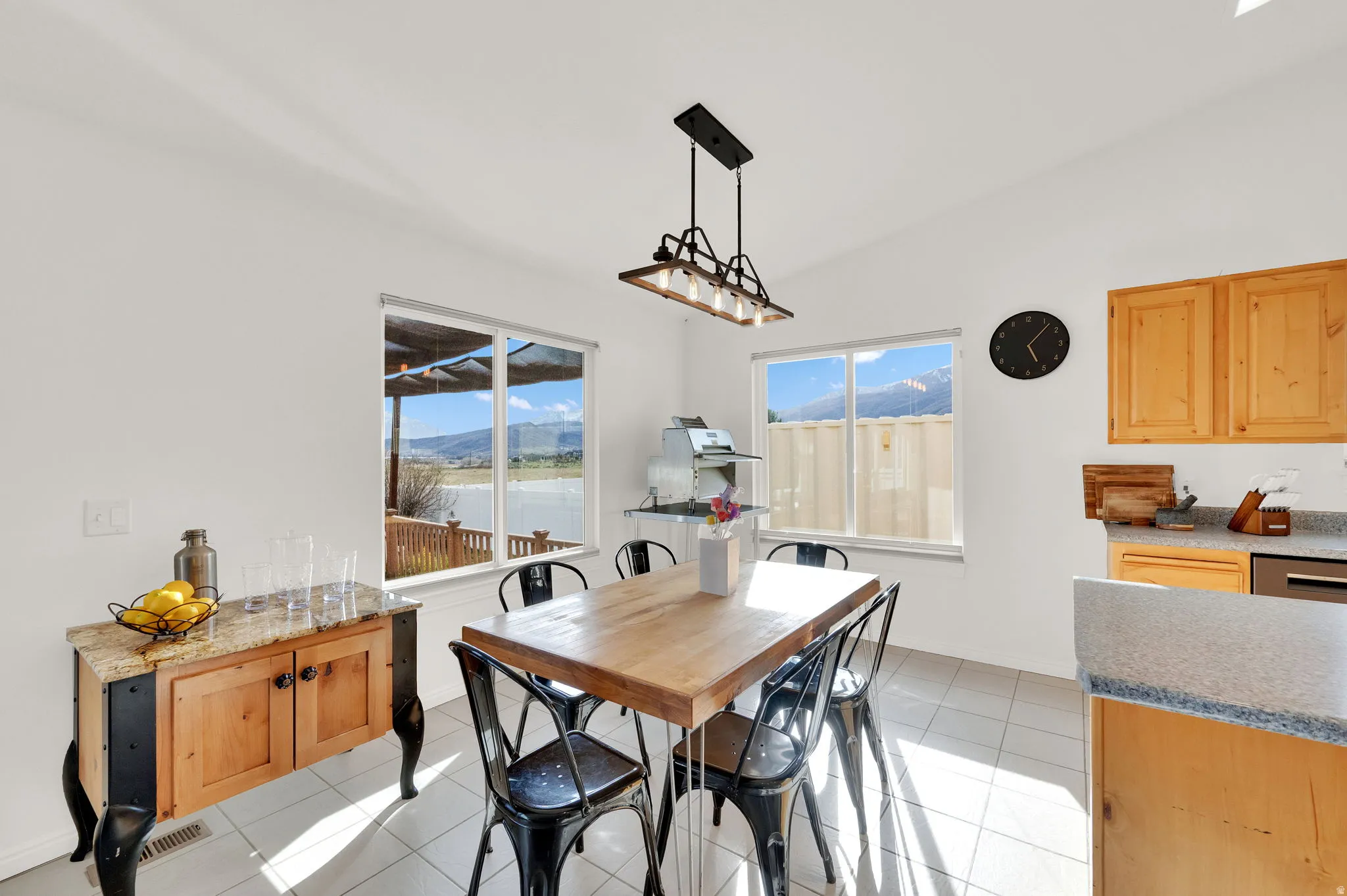Dining area featuring decorative light fixture and mountain views