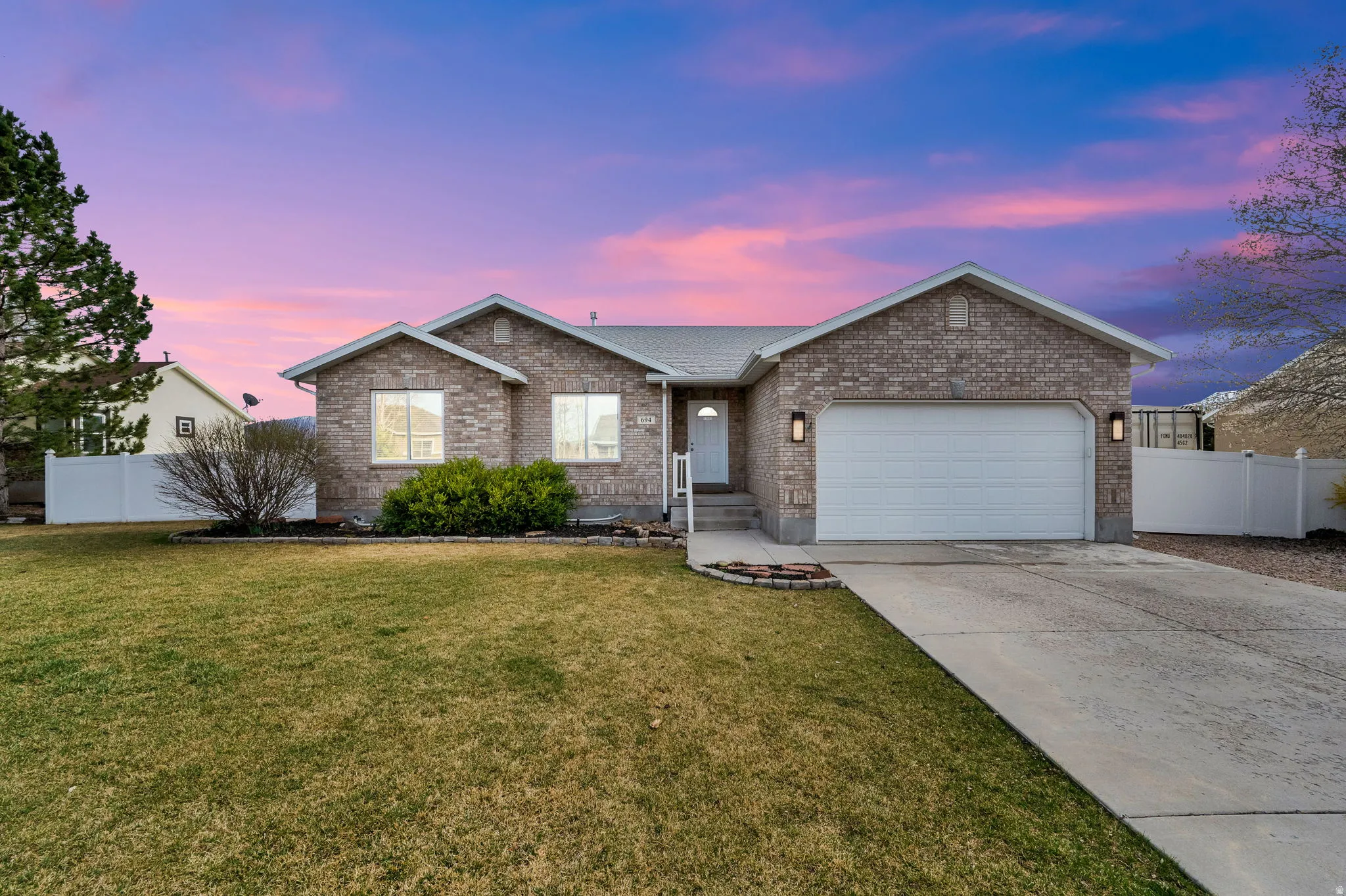 Front of home, brick rambler, 2-car garage.
