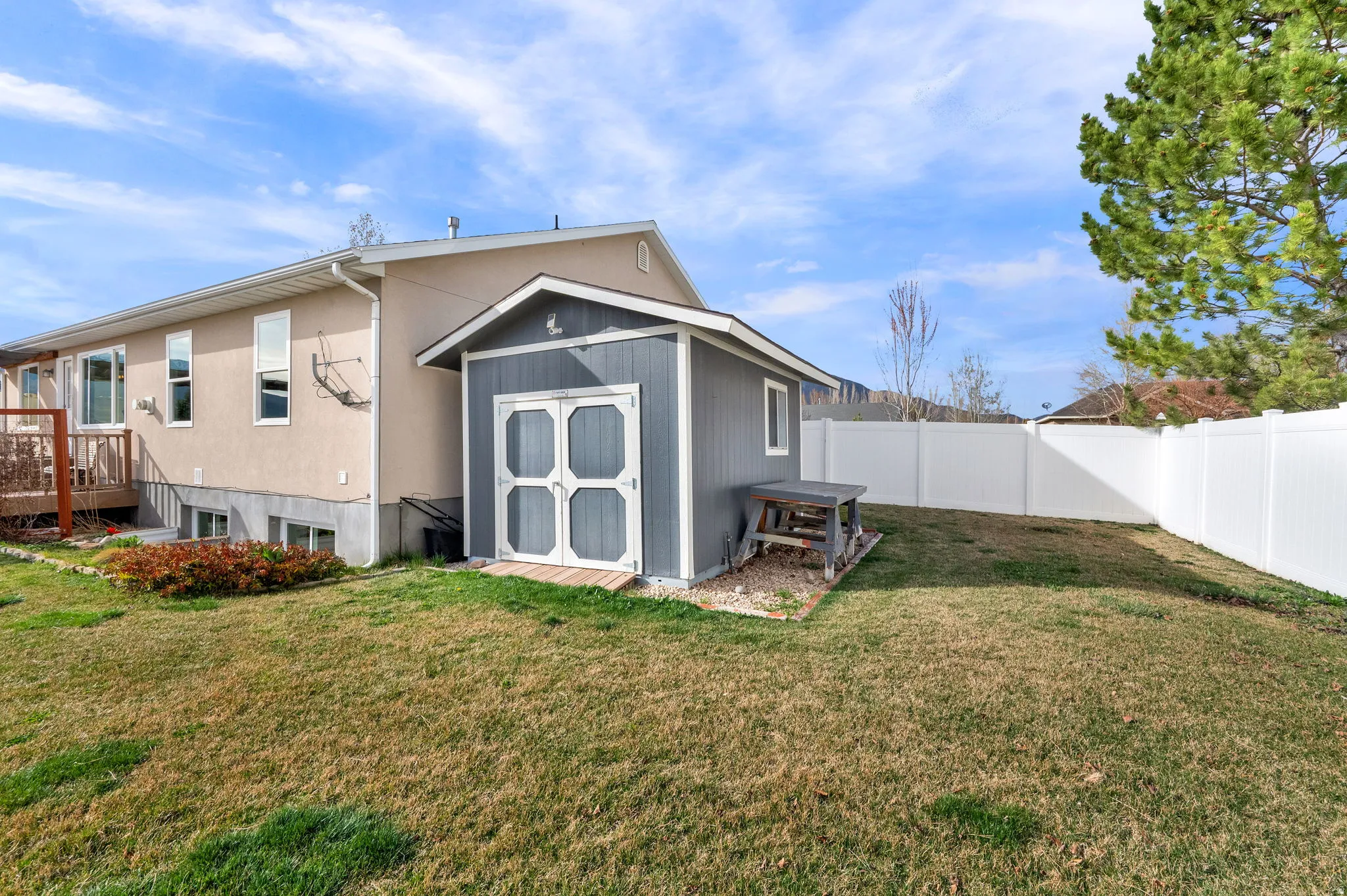 Back of property with a storage shed,