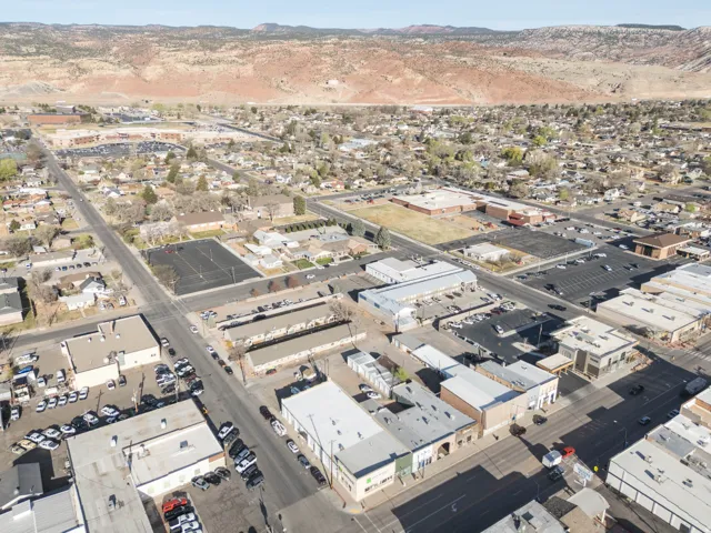 Aerial view of property and surrounding area featuring a mountain backdrop
