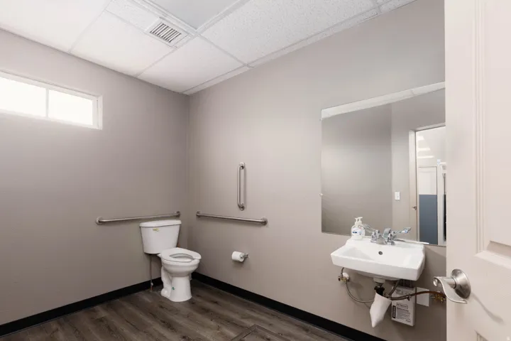 Half bathroom featuring a paneled ceiling and dark wood-type flooring