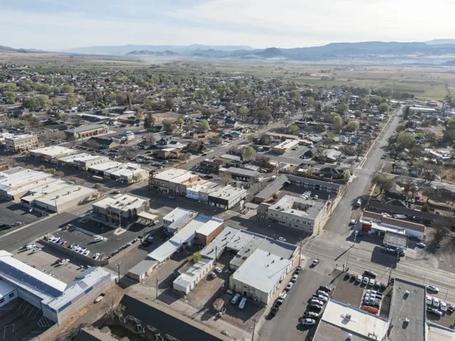 Aerial view of property and surrounding area featuring mountains