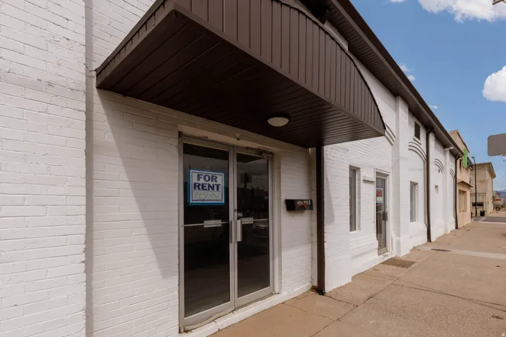 View of exterior entry with brick siding