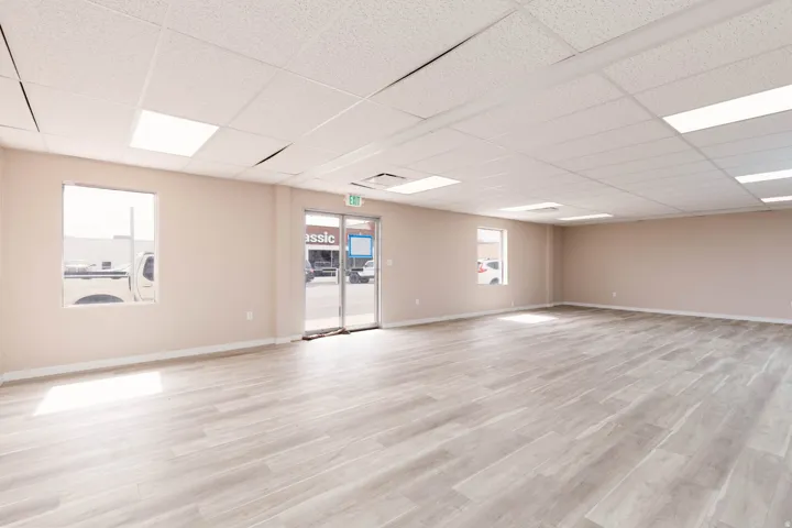 Unfurnished room featuring light wood-style flooring and a drop ceiling