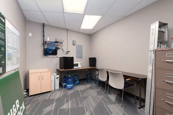 Office space with a paneled ceiling and electric panel