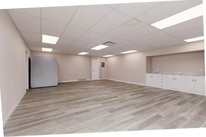 Spare room featuring light wood-style flooring and a paneled ceiling