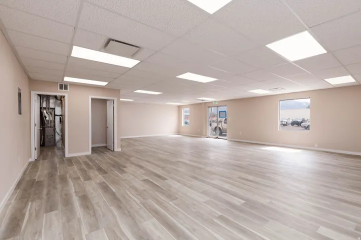 Unfurnished room featuring a drop ceiling and light wood-style floors