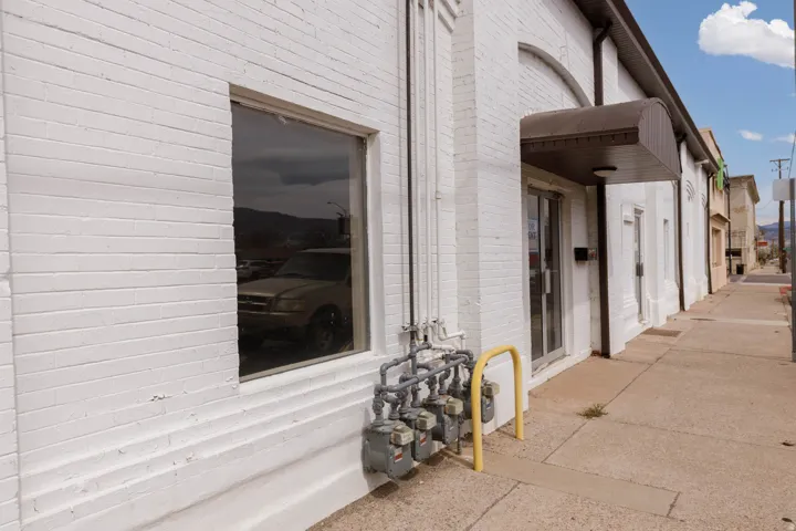 Doorway to property featuring brick siding
