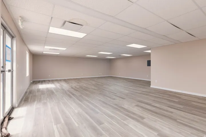 Empty room featuring a paneled ceiling and light wood-style floors