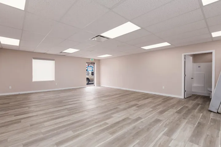 Spare room featuring light wood finished floors and a paneled ceiling