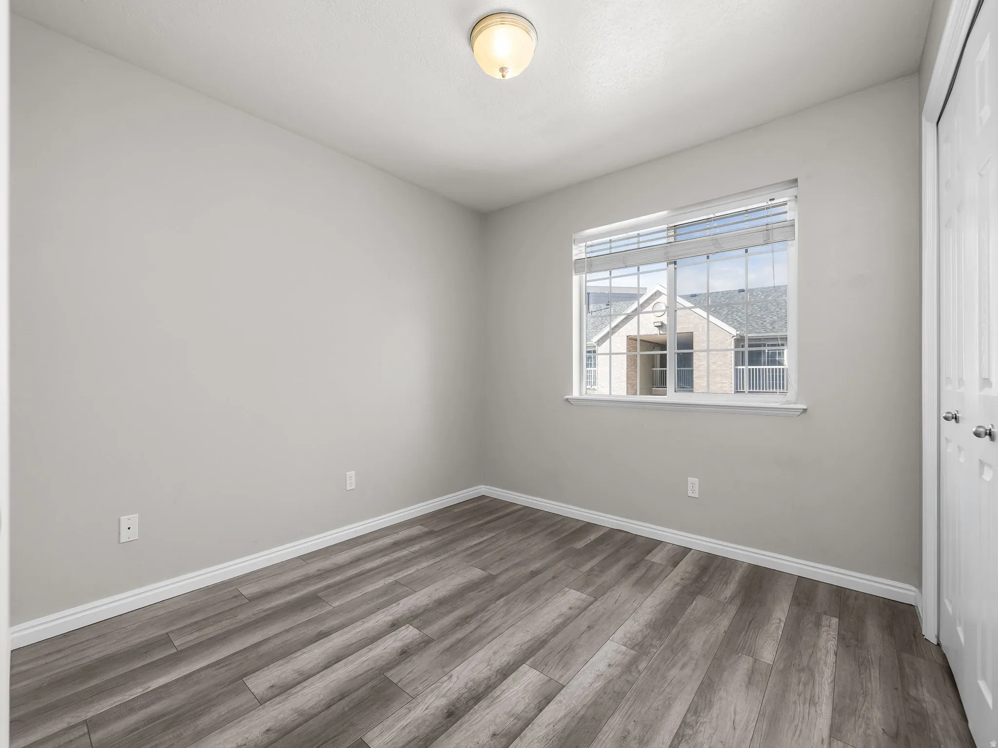 Spare room with wood finished floors and baseboards