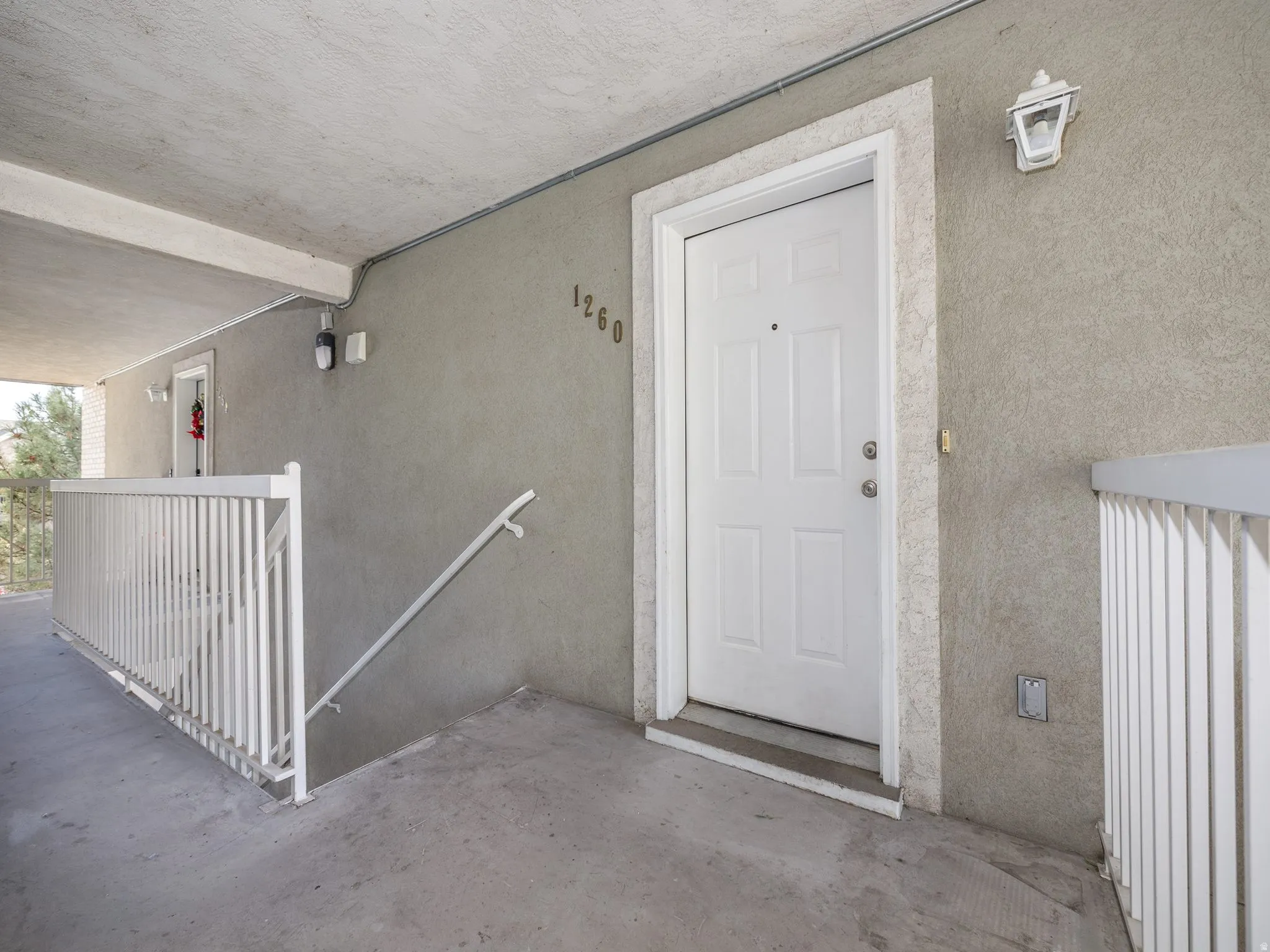 View of exterior entry with stucco siding