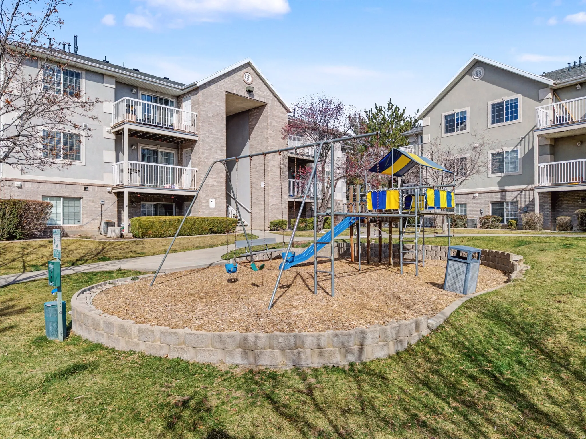 Community jungle gym featuring a yard and a balcony