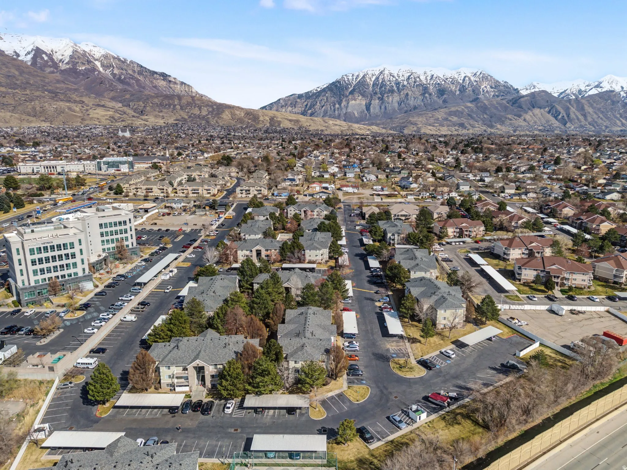 Aerial view of property and surrounding area with a mountain backdrop